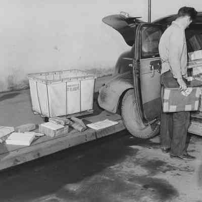 Photograph of man with car full of packages, 1947