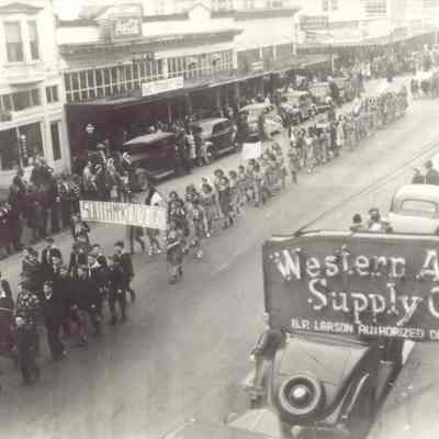 Photograph of parade with South McKenzie District Sign
