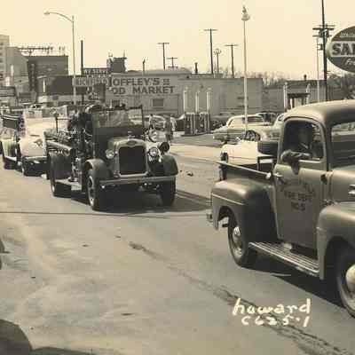 Photograph of fire trucks in parade on Main Street, Springfield, Oregon, date unknown.