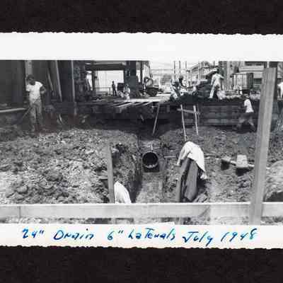Photograph of unknown men working on a 24" Drain at Booth Kelly Lumber Mill, Springfield, Oregon, 1948