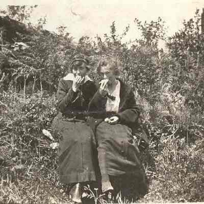 Photograph of Edythe Laxton and friend on a bench