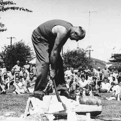 Photograph of Bill Johnston in a log chopping competition, date unknown