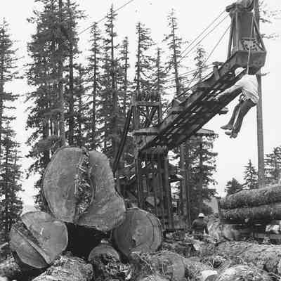 Photograph of a unidentified man hanging on a cable