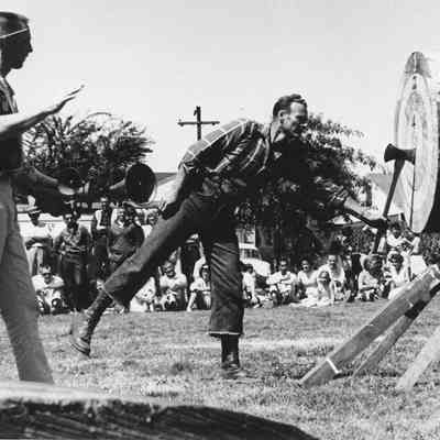 Photograph of two men at an axe throwing contest, date unknown