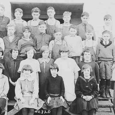 Photograph of elementary students posed outside school, Springfield, Oregon, date unknown.