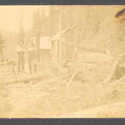 Photograph of Faye Abrams and another unidentified man by a ruined building