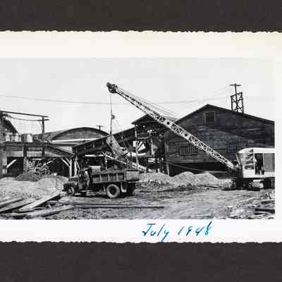 Photograph of the draining or filling of the old log pond at the Booth-Kelly Lumber Mill