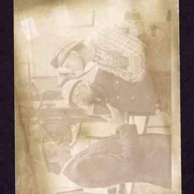 Photograph of 2 workers and a man in a suit, undated