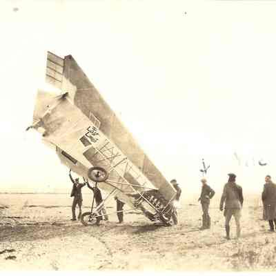 Photograph of 7 men around an early aircraft