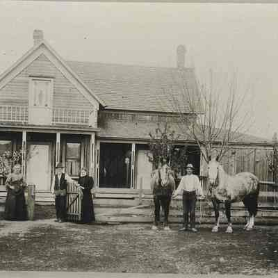 Old Anderson house with people and horses, 1895