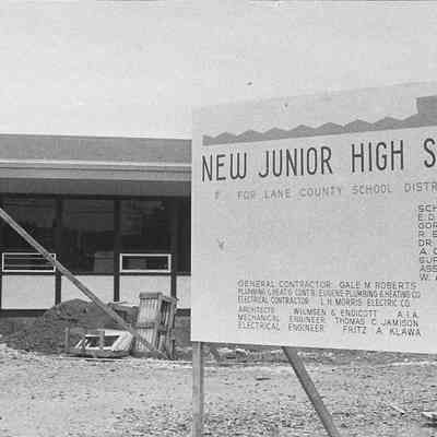 Photograph of construction sign for new Springfield junior high building, Springfield, Oregon, date unknown.