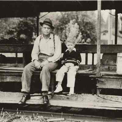 Photograph of man and boy on railcar under cover, 1941