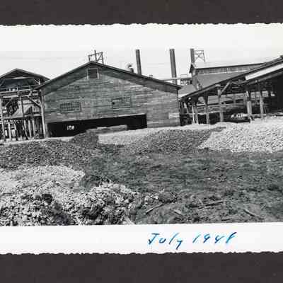 Photograph of the filling of the old log pond at Booth-Kelly Lumber Mill