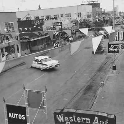 Photograph of Main Street with Shoppers Paradise, taken from rooftop, Springfield, Oregon, 1957