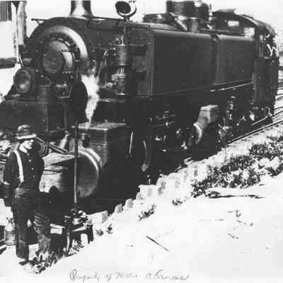 Photograph of Booth-Kelly Train Engine with unidentified man standing in front, Leaburg Lake Park, Oregon