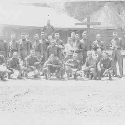 Photograph of military personnel in front of tent barracks, circa 1920s