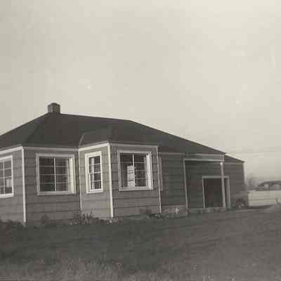 Photograph of a hip-roofed cottage with car garage, Springfield, Oregon, 1953