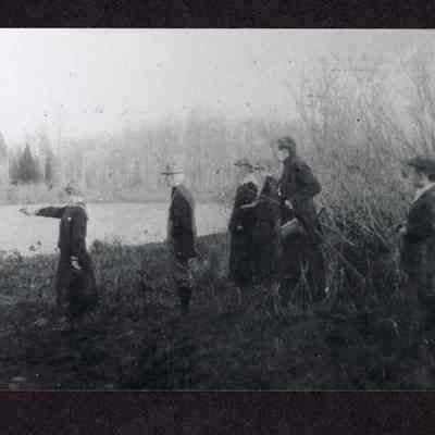 Photograph of Dorothy Andrews pointing a hand gun at a river, circa 1918