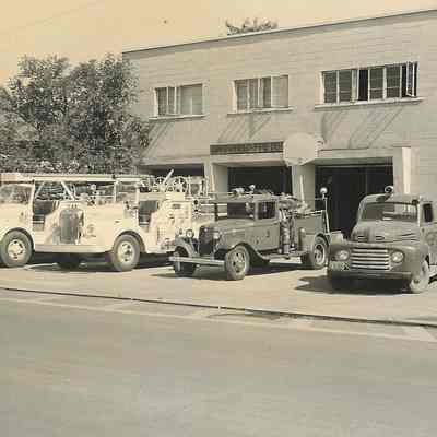 Photograph of front of fire department, with hose trucks and smaller trucks, Springfield, Oregon, 1952