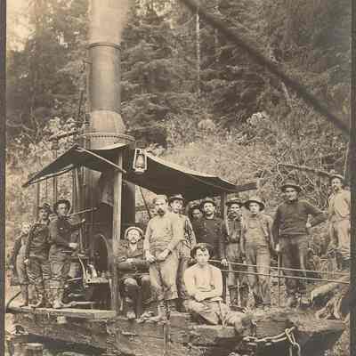 Photograph of steam donkey and crew on a sledge