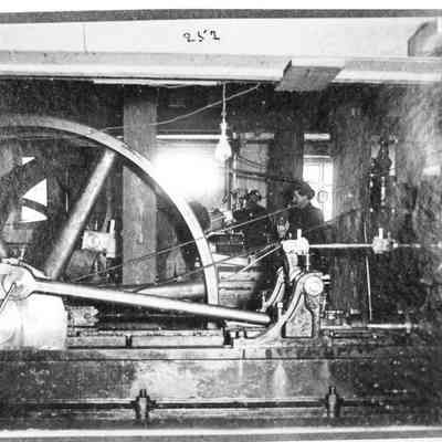 Photograph of two men behind the electric belt drives at Booth-Kelly Mill, Wendling, Oregon