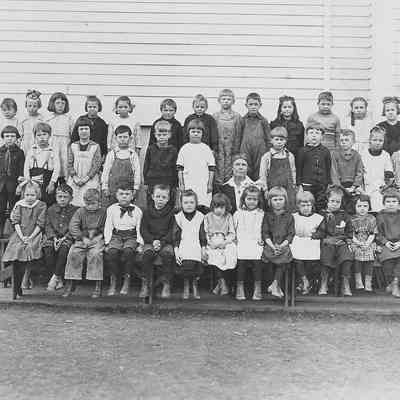 Photograph of students posing outside with teacher Elizabeth Page, Springfield, Oregon, date unknown.