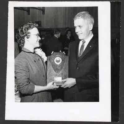 Photograph of 2 people receiving an award, Unknown date and location