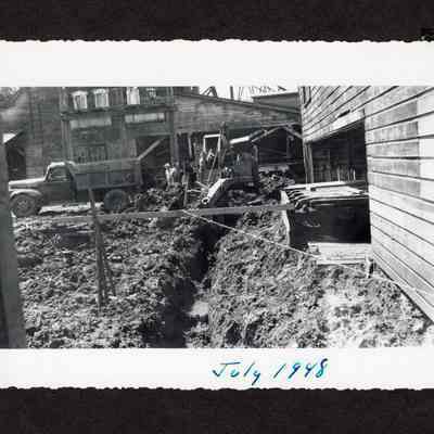 Photograph of an excavator digging path in the ground at Booth-Kelly Lumber mill drainage construction site, Springfield, Oregon, 1948
