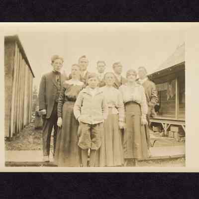Photograph on postcard of unknown family photograph with 9 people
