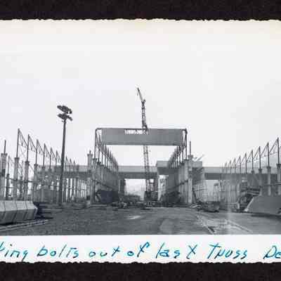 Photograph of taking bolts out of last truss, 1948