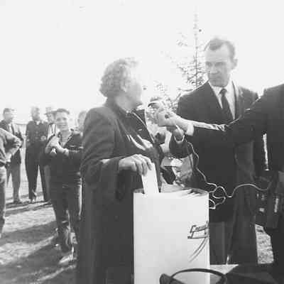 Photograph of two people adding item to Oregon Centennial time capsule, 1959