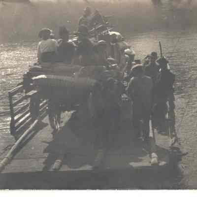 Photograph of ferry loaded with people crossing river