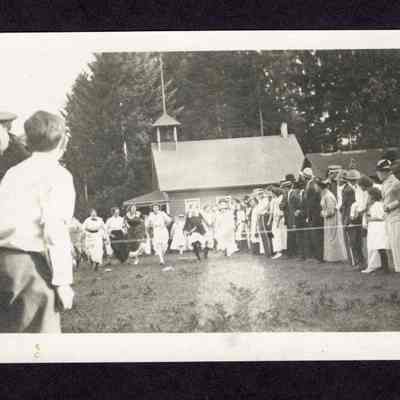 Photograph on postcard of married women's race from the lodge picnic at the Camp Creek School