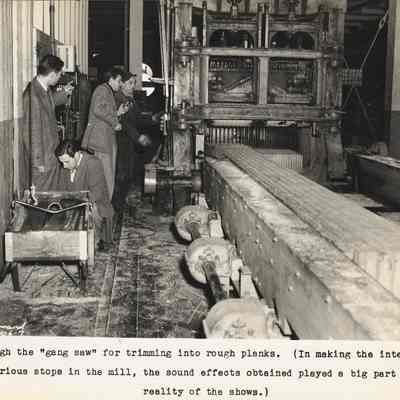 Photograph of three unknown men and sawmill worker in mill at the gang saw, Springfield, Oregon, circa 1945-1951