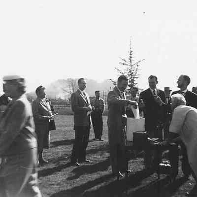 Photograph of man adding item to Oregon Centennial time capsule, 1959.