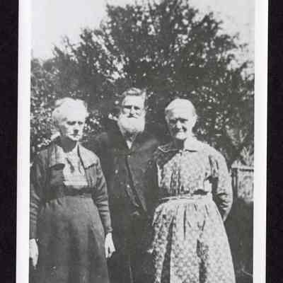Photograph of two women and one man