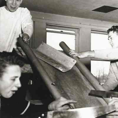 Photograph of three boys participating in an activity at the Springfield High carnival, circa 1940s