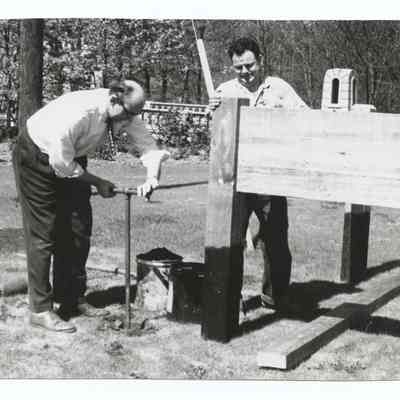 Photograph of the installation of a sign, near Main Street Bridge, 1962