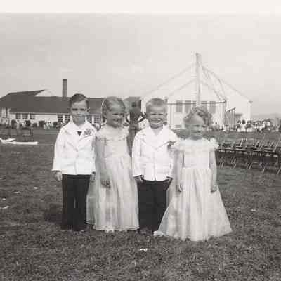Photograph of four small children standing outside at the Springfield High School Springfest, Springfield, Oregon, 1947