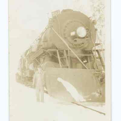 Photograph of Harry Fox next to the South Pacific train '5220' (?), undated
