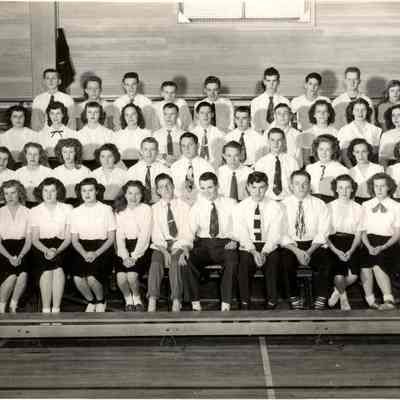 Photograph of high school students seated on gym bleachers, 1949.