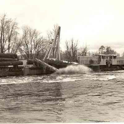 Photograph of Logs being unloaded from a Log Pond, undated