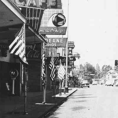 Photograph of flags along a sidewalk on Main Street, Springfield, Oregon, date unknown