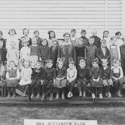 Photograph of primary students with teacher Elizabeth Page, Springfield, Oregon, date unknown.
