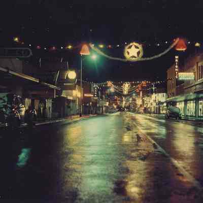 Photograph of Main Street at Christmastime, lighted decorations, 1955