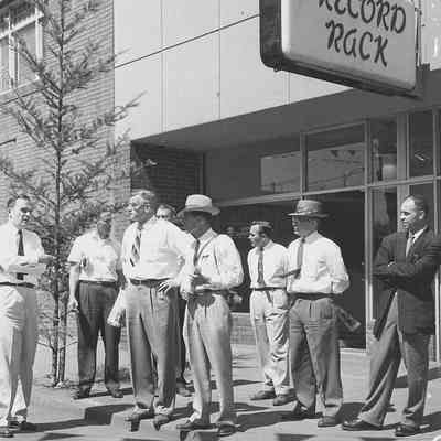 Photograph of city officials in front of Record Rack on Main St, Springfield, Oregon, 1957