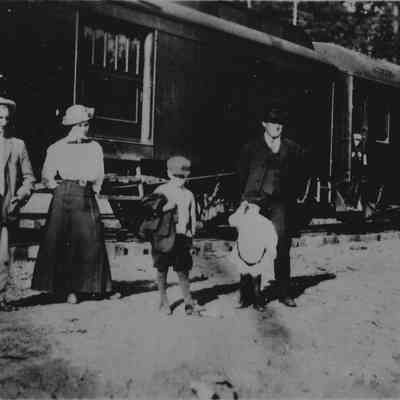 Photograph of six people in front of a train that runs from Noti to Springfield, Noti, Oregon, circa 1910
