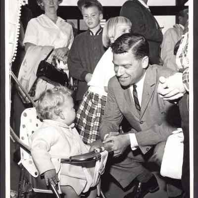Photograph of Governor Mark O. Hatfield talking to a child. Date unknown.