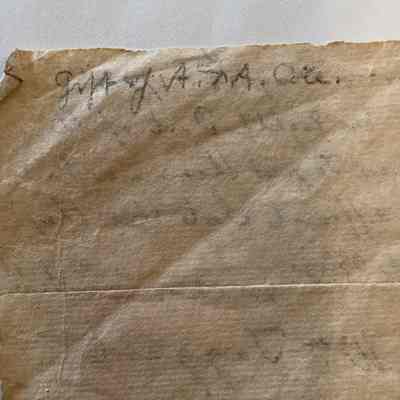 Close up of upside-down writing in pencil on back