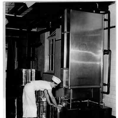 Blount Seafood Corp Warren R.I. Stanly Krychta filling cans with clam broth which has been precooled in equip. shown here 25x20 glossy black and white